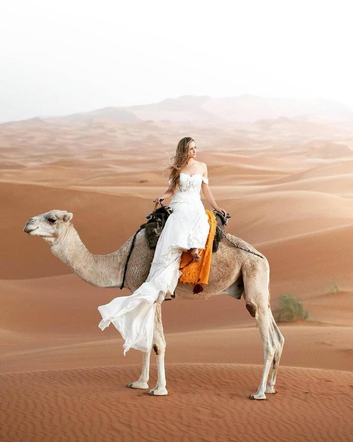 Sahara Majestic Luxury Camp Hotel Merzouga Luaran gambar A woman riding a camel in the desert